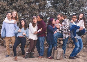 multigenerational family with multiple couples embracing